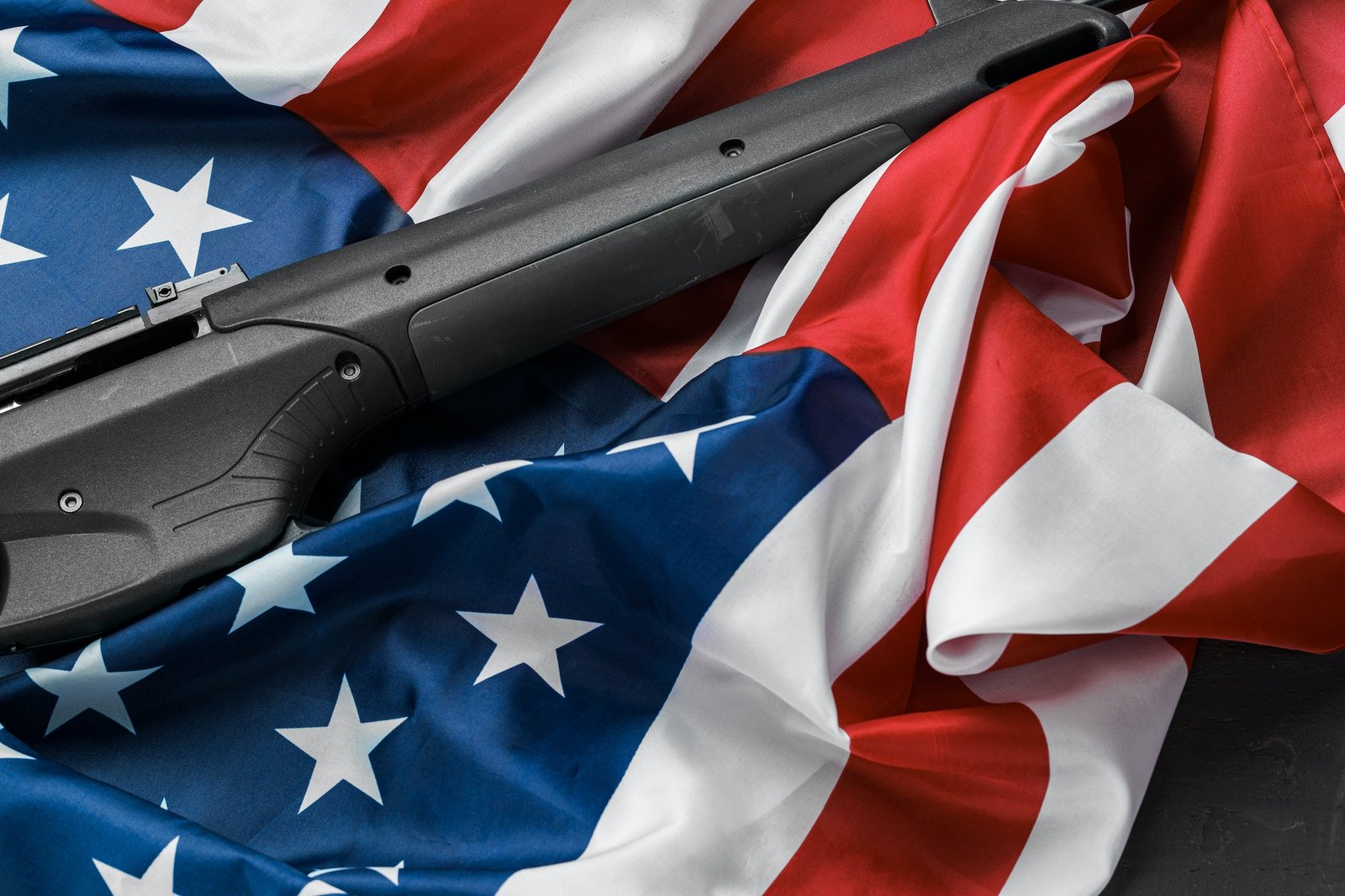automatic-rifle-on-usa-flag-on-wooden-background automatic-rifle-on-usa-flag-on-wooden-background